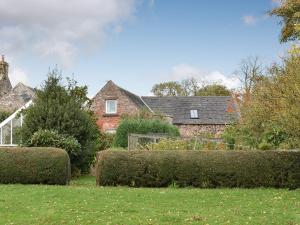 a group of hedges in front of a house at Fairlaw Garden Cottage in Reston