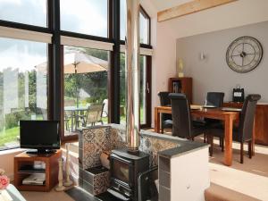 a living room with a fireplace and a table with chairs at Achabeg - S4597 in Taynish