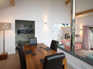 a dining room and living room with a table and chairs at Achabeg - S4597 in Taynish