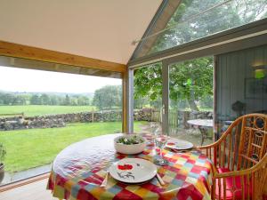 a table with a bowl of food on top of it at Tullibole Castle Longhouse in Crook of Devon