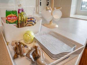 a drawer in a refrigerator filled with food and snacks at Granary Cottage - Uk10695 in Amroth