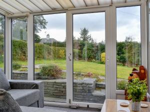 a screened in porch with sliding glass doors at Hillside Cottage in Keswick +17 photos