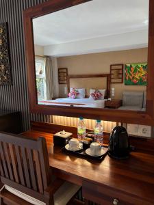 a room with a table with a bed and a mirror at Sari Villa Ubud in Ubud