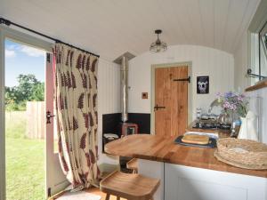 a kitchen with a wooden counter top and a table at Ryeland Hut - Qu7632 in Messing