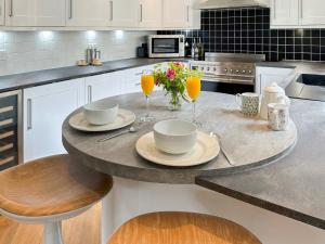 a kitchen with a table with two glasses of orange juice at Tigh-Na-Creige in Feorlean