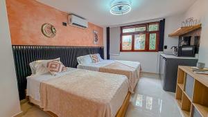 a hotel room with two beds and a kitchen at Primavera Lofts in Medellín