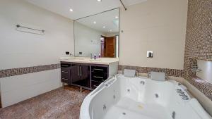 a large bathroom with a tub and a sink at Primavera Lofts in Medellín +113 photos