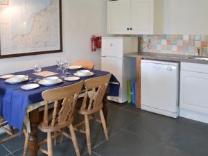 a kitchen with a table with wine glasses on it at Culvada in Treknow