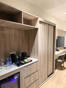 a kitchen with wooden cabinets and a counter top at فندق فاليرا باي - محايل عسير VALERA BAY Hotel in Muhayil +16 photos