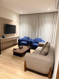 a living room with two couches and a tv at فندق فاليرا باي - محايل عسير VALERA BAY Hotel in Muhayil