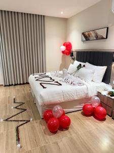 a room with a bed with balloons on the floor at فندق فاليرا باي - محايل عسير VALERA BAY Hotel in Muhayil
