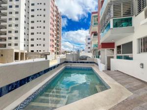 a swimming pool on the roof of a building at Colinas del Sol Res perfect in Jacagua