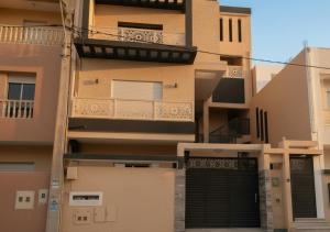 an exterior view of a building with a garage at Dar Al Yaqout in Le Kram