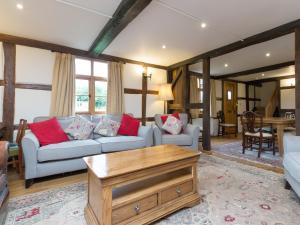 a living room with two couches and a coffee table at Brook House in Mathon