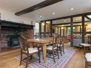 a dining room with a wooden table and chairs at Brook House in Mathon