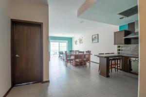 a kitchen and dining room with a table and chairs at Pacifika in Mazatlán