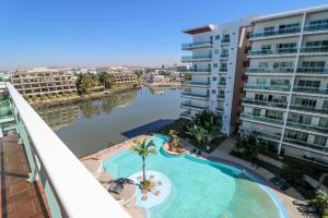 a view from the balcony of a apartment building with a pool at Pacifika in Mazatlán