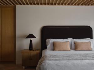 a bed with a black headboard and two pillows at The Ivory in Los Angeles +10 photos