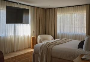 a hotel room with a bed and a television at The Ivory in Los Angeles