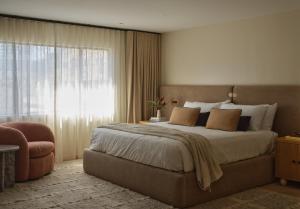 a bedroom with a large bed and a large window at The Ivory in Los Angeles