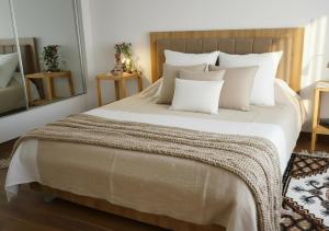 a bedroom with a large bed with white pillows at Dar Al Yaqout in Le Kram