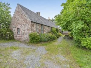 an old stone house with a pathway leading to it at The Cottage in Bankfoot