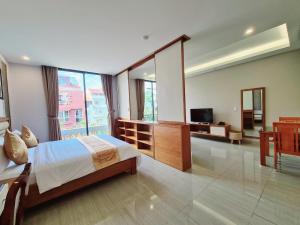 a bedroom with a bed and a television in it at GreenStay Hotel & Apartment in Ho Chi Minh City
