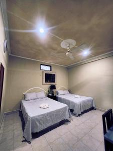 a room with two beds and a ceiling at Posada Azeneth in Oxkutzcab