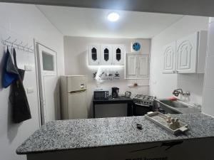 a kitchen with white cabinets and a counter top at Backpacker Room 2 in Aswan