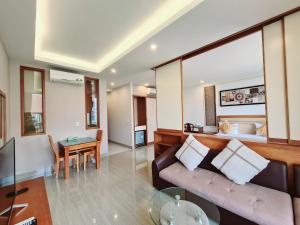 a living room with a couch and a table at GreenStay Hotel & Apartment in Ho Chi Minh City