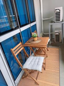 a wooden table and a chair on a balcony at Parksuites Tower 2 in Manila