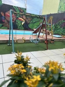 a mural of a pool with a swing at Espaço festa Angini in Manaus