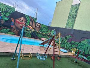 a mural on the side of a building with a painting at Espaço festa Angini in Manaus