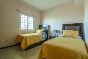 a bedroom with two beds and a window at Pacifika in Mazatlán +35 photos