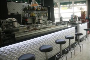 a bar with black stools in a restaurant at Hostal El Altet in El Alted