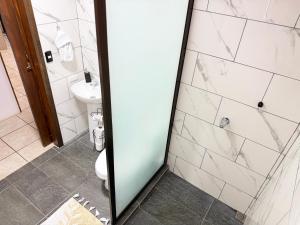 a bathroom with a shower and a toilet at Retiro Arenal in Fortuna +9 photos