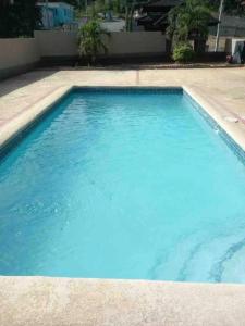 a swimming pool with blue water at Serenity Vacation Villa in Ocho Rios