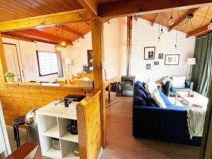 a living room with a blue couch in a room at Cozy chalet for 6 people in Rendeux +29 photos