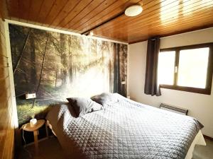 a bedroom with a bed and a large window at Cozy chalet for 6 people in Rendeux
