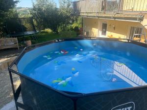 a large blue swimming pool in a yard at Ferienwohnung Sorpesee in Sundern