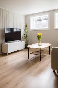 a living room with a tv and a table at Cozy apartment in Sola