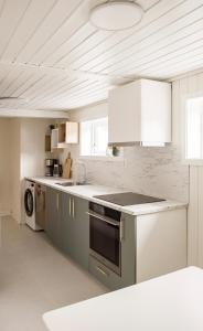 a kitchen with a sink and a stove top oven at Cozy apartment in Sola