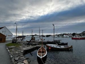 a group of boats are docked in the water at Cozy apartment in Sola