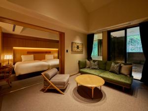 a room with a bed and a couch and a table at Hakone Suishoen in Hakone +34 photos