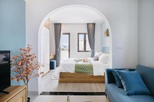 a bedroom with a bed and a blue couch at Artsy Boutique Studio in Hanoi