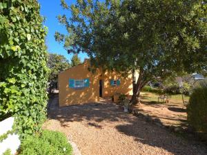 a small yellow house with a tree in front of it at Delightful, authentic Quinta with pool in Loulé +94 photos