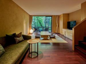 a living room with a couch and a table at Hakone Suishoen in Hakone