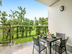 a table and chairs with a view of a garden at Mobilehome am Luganersee in Porlezza