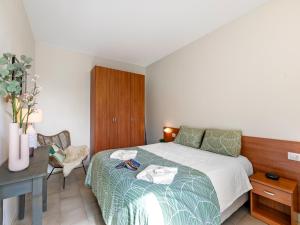 a bedroom with a bed with a table and a desk at Mobilehome am Luganersee in Porlezza