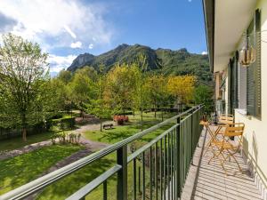 a balcony with a view of a park and mountains at Mobilehome am Luganersee in Porlezza